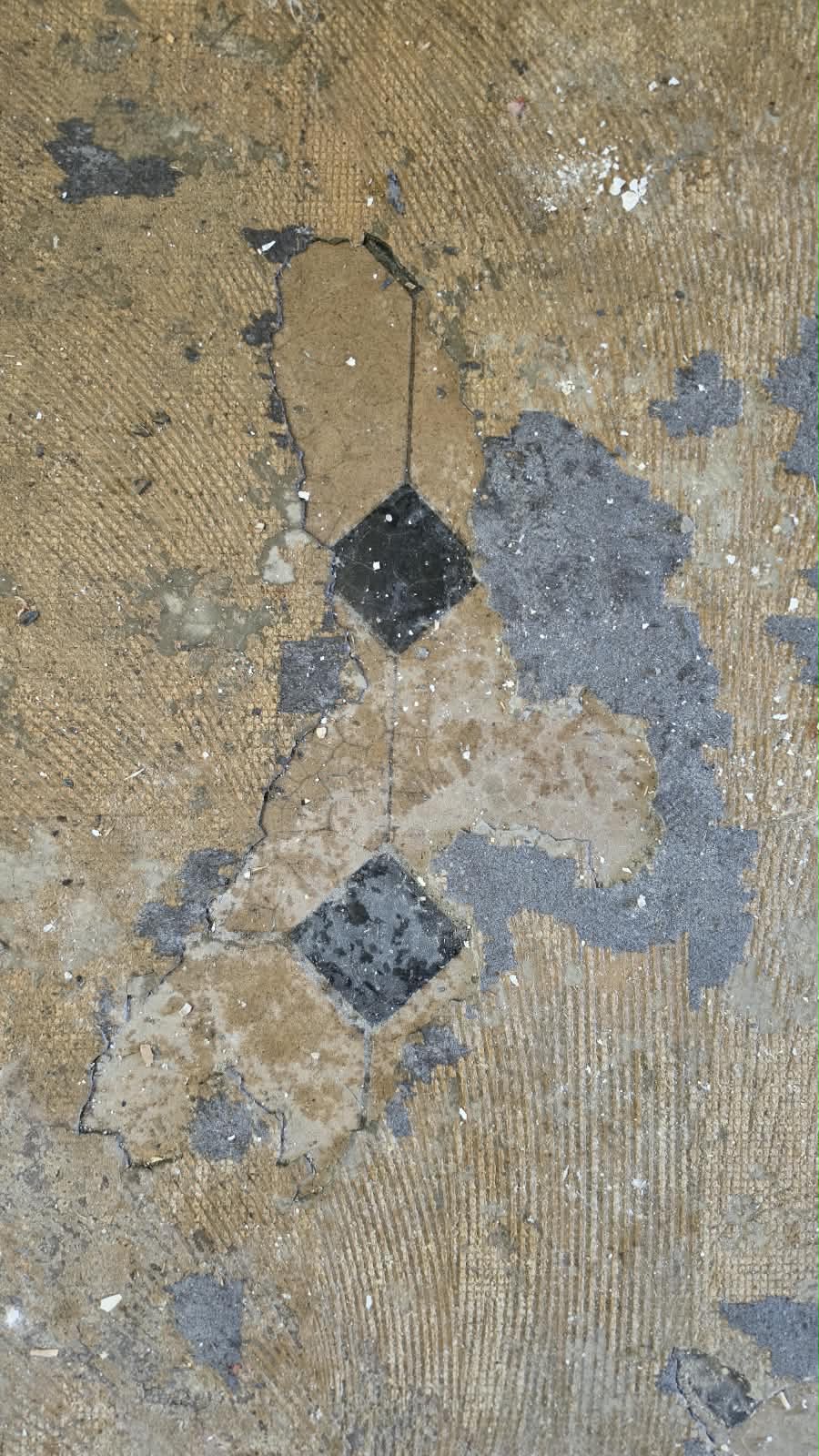 Dark diamond tiles beneath old floor coverings at SoHome Lausanne