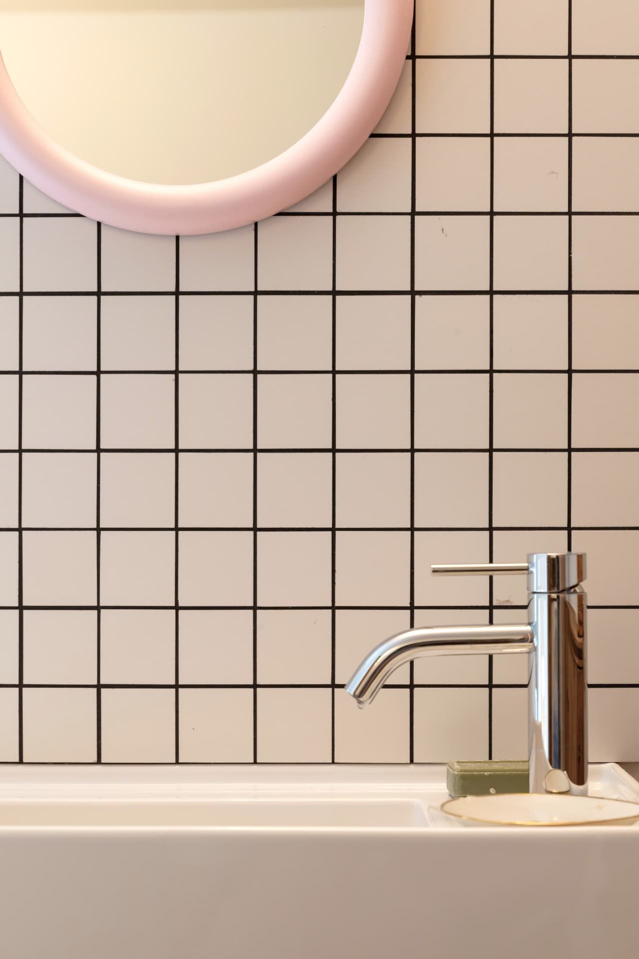 The pink mirror above the washbasin at SoHome Le Châble
