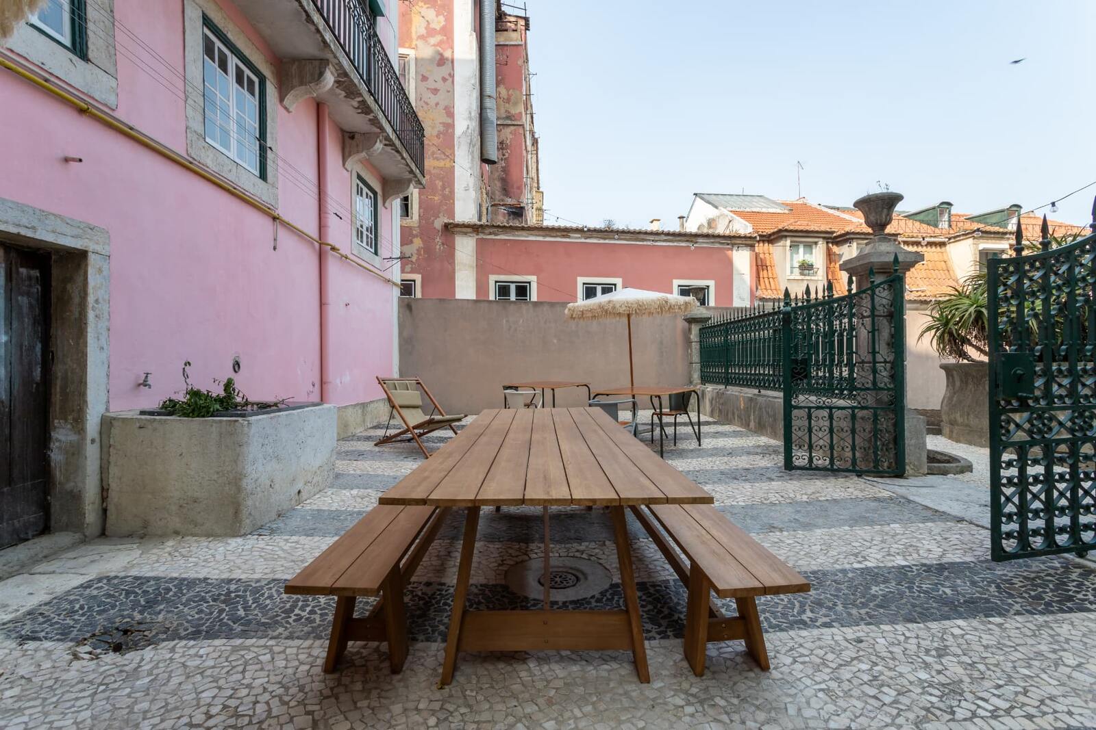The courtyard with a communal table in the Lisbon house