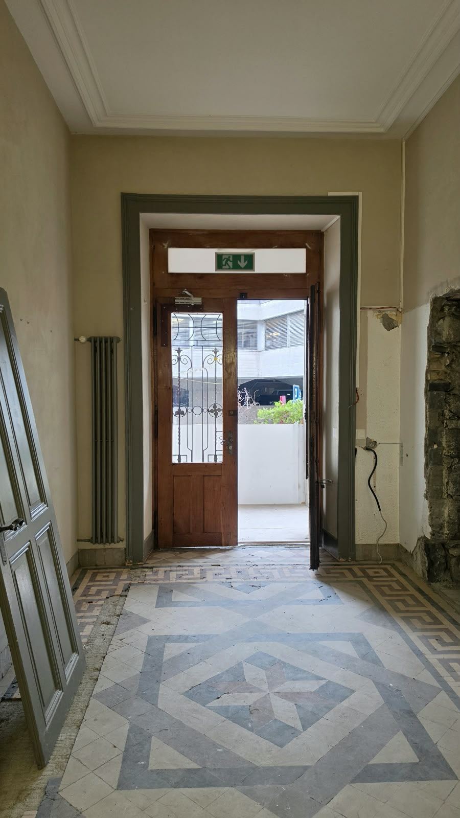 The original entrance hall with its patterned tile floor at SoHome Lausanne