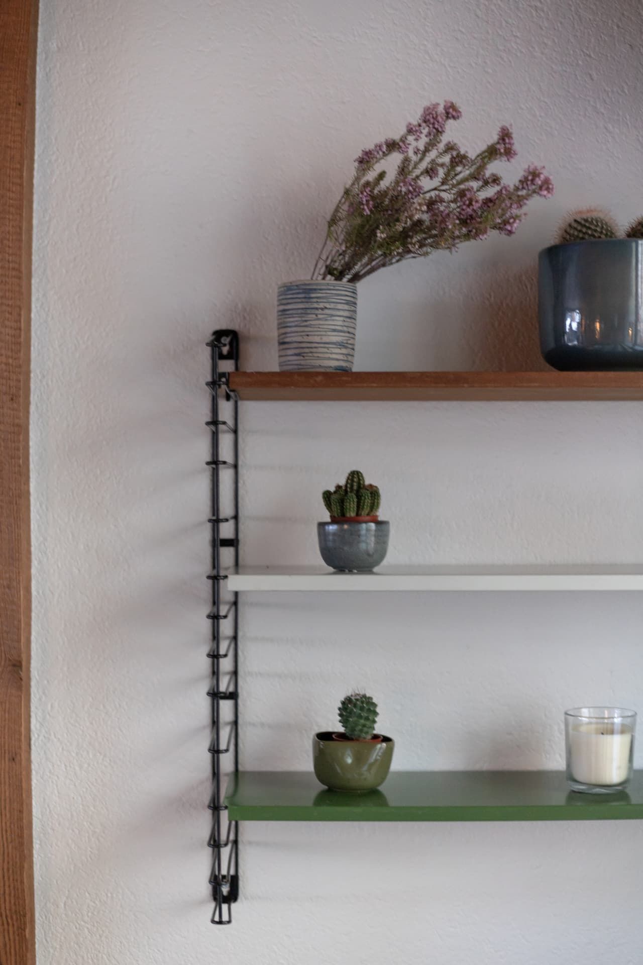 Shelves with cacti and a candle at SoHome Le Châble