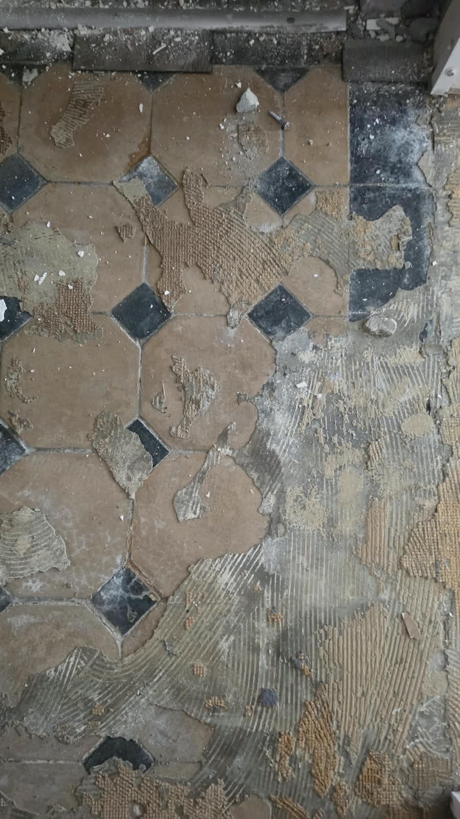 Original terracotta and dark floor tiles uncovered at SoHome Lausanne