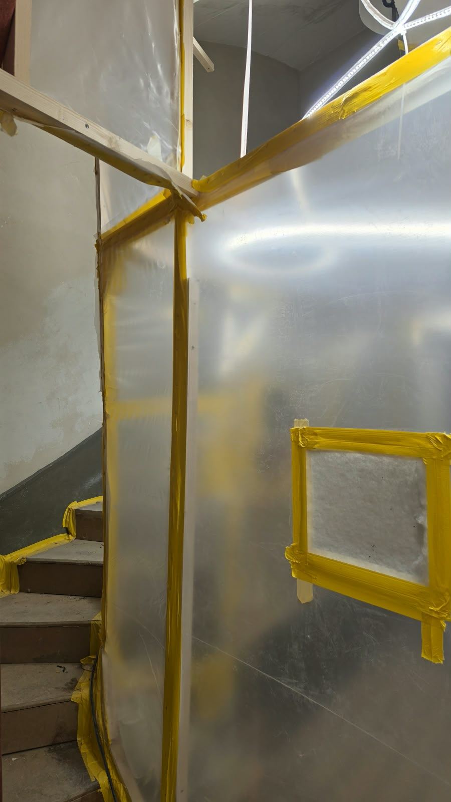 The spiral staircase protected behind sheeting during the Lausanne renovation