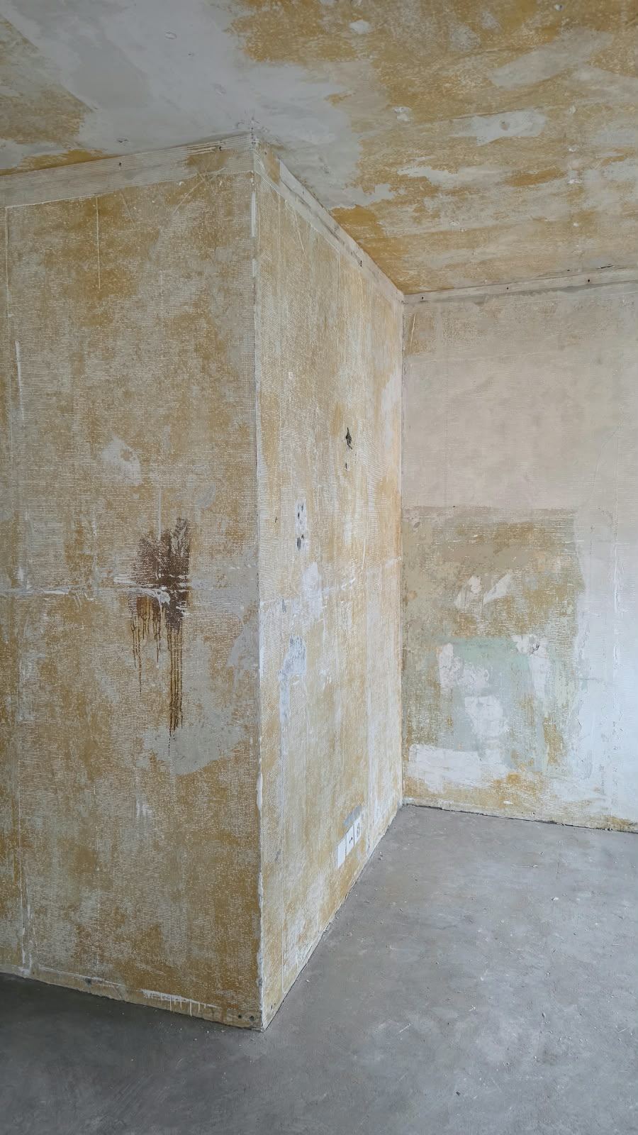 Stripped plaster walls in an emptied room at SoHome Lausanne
